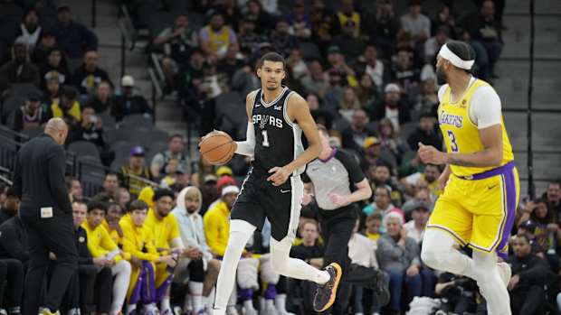Dec 13, 2023; San Antonio, Texas, USA; San Antonio Spurs center Victor Wembanyama (1) dribbles the ball in front of Los Angeles Lakers forward Anthony Davis (3) in the first quarter at the Frost Bank Center.